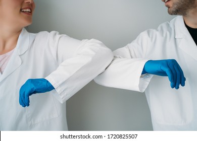 Elbow Bumping. A New Way Of Greeting To Prevent The Spread Of The Coronavirus (COVID-19). Two Doctors Bump Elbows Instead Of Greeting With A Hug Or A Handshake In The Hospital.