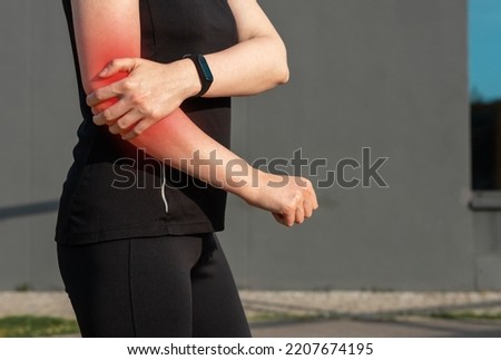 Elbow pain, sport trauma of woman athlete. High quality photo