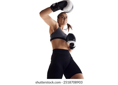 Elbow strike. Muscular young woman, determined boxing athlete in motion, training, fighting isolated on white studio background. Bottom view. Concept of sport, hobby, active and healthy lifestyle - Powered by Shutterstock