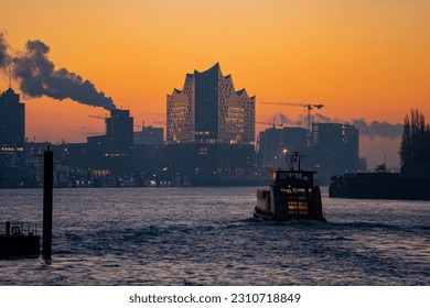 The Elbphilharmonie Hamburg - Elbe Philharmonic Hall during a beautiful sunrise at the Hamburg Hafencity, in front is the Elbe