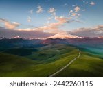 Elbrus mount with clouds at sunrise. Gil-Su valley in North Caucasus, Russia. Aerial view. Beautiful summer landscape