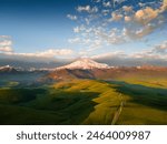 Elbrus mount with clouds at sunrise. Gil-Su valley in North Caucasus, Russia. Aerial view. Beautiful summer landscape