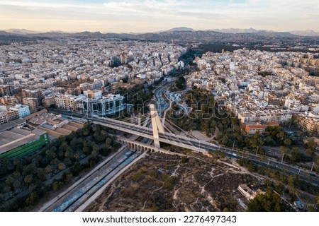 Elche's Pont de la Generalitat at foreground and Elche city, Palmeral and Vinalopo river at background. Drone view