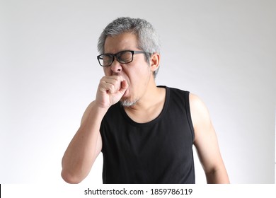 The elder Asian man in sport uniform standing on the white background. - Powered by Shutterstock