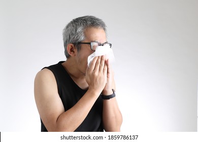 The elder Asian man in sport uniform standing on the white background. - Powered by Shutterstock