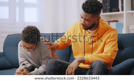 Elder brother supporting upset little boy, family care, brotherly love