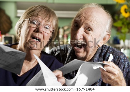 Elder Couple at Home with Bills