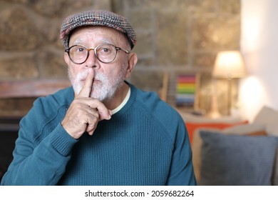 Elder man bringing finger to lips