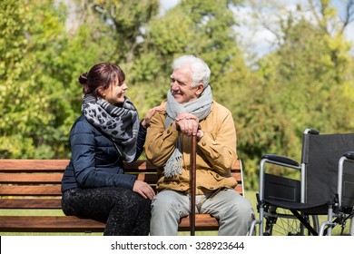 Elder Man And Carer In The Park