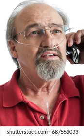 Elder Man With COPD Talking On The Phone While Wearing An Oxygen Cannula For Supplemental Air.