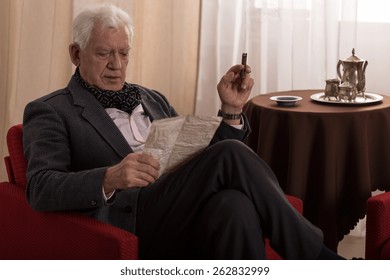 Elder Man Reading Old Letter And Smoking Cigar