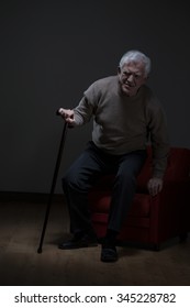 Elder Man Trying To Stand Up Using Walking Stick