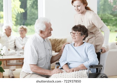 Elder man visiting his wife with Alzheimer's disease at the rest home