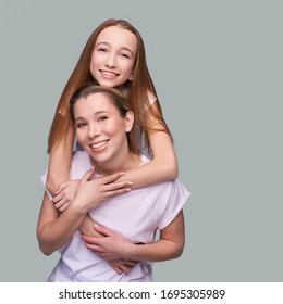 Elder Mother And Teenager Daughter Hug. Happy Family Portrait. Similar Smile. Next Generation Love. Single Mom. Mature Parent. Smiling People Group. Attractive Posing Together. Two Hand Connection