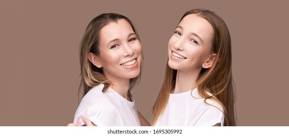 Elder Mother And Teenager Daughter Hug. Happy Family Portrait. Similar Smile. Next Generation Love. Single Mom. Mature Parent. Smiling People Group. Attractive Posing Together. Two Hand Connection