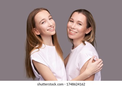 Elder Mother And Teenager Daughter Hug. Happy Family Portrait. Similar Smile. Next Generation Love. Single Mom. Mature Parent. Smiling People Group. Attractive Posing Together. Two Hand Connection