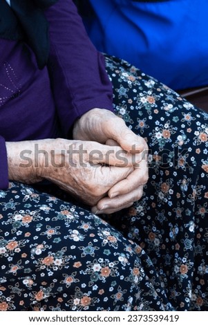 Elder woman hand. Old woman's freckled hands in her lap. Past years, memories figurative meaning. Vertical photo. People, human, model. Fingers and nails.