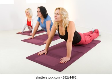 Elder Women During Exercising On Mat.