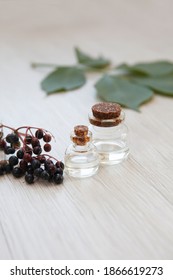 Elderberry Essential Oil Bottle  (tincture, Extract, Infusion) With Fresh Elderberry On Wooden Background