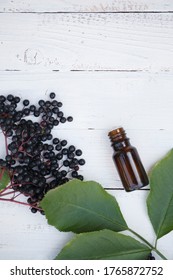 Elderberry Essential Oil (tincture, Extract, Infusion) With Fresh Elderberry On Wooden Background