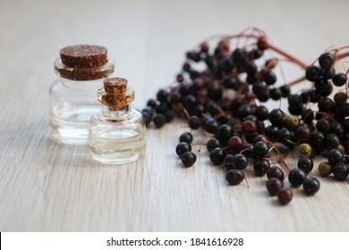 Elderberry Essential Oil (tincture, Extract, Infusion) With Fresh Elderberry On Wooden Background