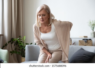 Elderly 60s Woman Got Up From Couch Felt Severe Painful Feelings In Lumbar, Massaging Low Back To Reduce Ache, Suffer From Backache Discomfort, Diseases Of Older People, Sciatic Nerve Injury Concept