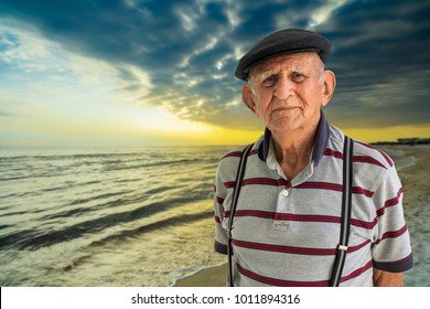 Elderly 80 Plus Year Old Man Outdoor Portrait Enjoying The Beach At Sunset.