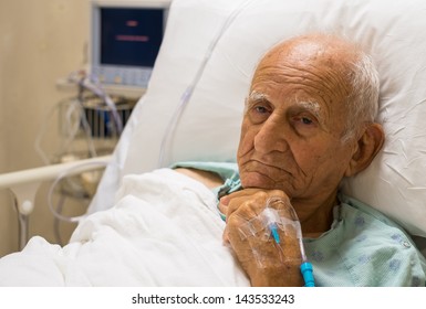 Elderly 80 Plus Year Old Man Recovering From Surgery In A Hospital Bed.