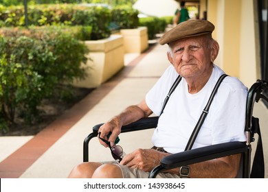 Elderly 80 Plus Year Old Man In A Wheel Chair Outdoors.