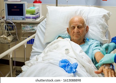 Elderly 80 Plus Year Old Man Recovering From Surgery In A Hospital Bed.