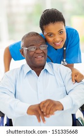 Elderly African American Man And Caring Young Caregiver At Home