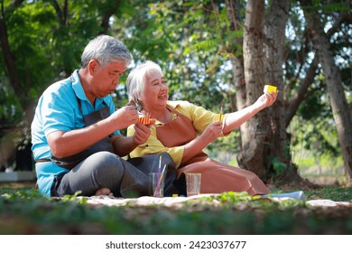 An elderly Asian couple does art activity painting ceramic pots in the garden outside. Living happily in retirement. art therapy - Powered by Shutterstock