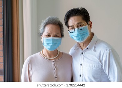 An Elderly Asian Couple Wearing Masks