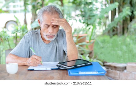 An Elderly Asian Man Working In The Garden At Home.