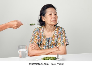 Elderly Asian Woman Bored With Food