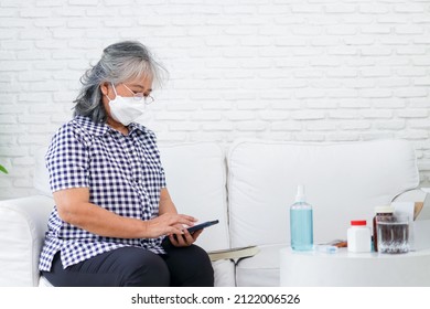 An elderly Asian woman called the doctor to inquire about her illness and how to keep herself at home. The concept of health care for the elderly. medical services. copy space