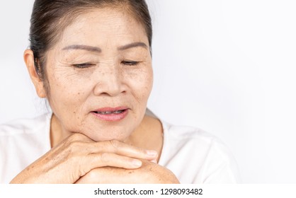 Elderly Asian Woman Portrait 60-70 Years Old With Black Hair And Hazel Eyes Looking Serious Thinking Isolated On White Background With Copy Space