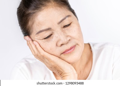 Elderly Asian Woman Portrait 60-70 Years Old With Black Hair And Hazel Eyes Looking Serious Thinking Isolated On White Background With Copy Space