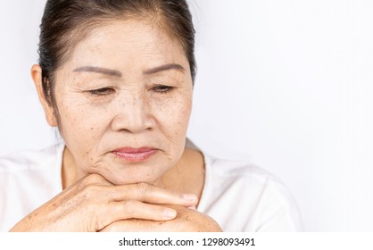 Elderly Asian Woman Portrait 60-70 Years Old With Black Hair And Hazel Eyes Looking Serious Thinking Isolated On White Background With Copy Space