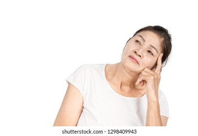 Elderly Asian Woman Portrait 60-70 Years Old With Black Hair And Hazel Eyes Looking Serious Thinking Isolated On White Background With Copy Space