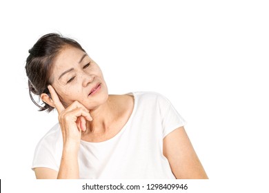 Elderly Asian Woman Portrait 60-70 Years Old With Black Hair And Hazel Eyes Looking Serious Thinking Isolated On White Background With Copy Space