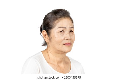 Elderly Asian Woman Portrait 60-70 Years Old No Make Up With White Clothes Black Hair And Hazel Eyes Isolated On White Background