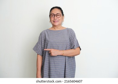 Elderly Asian Woman Smiling Happy With His Left Hand Pointing To The Right