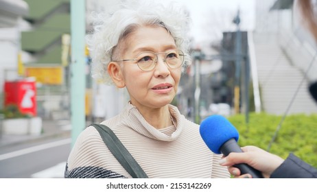 Elderly Asian Woman Taking Street Interview. TV Reporting.