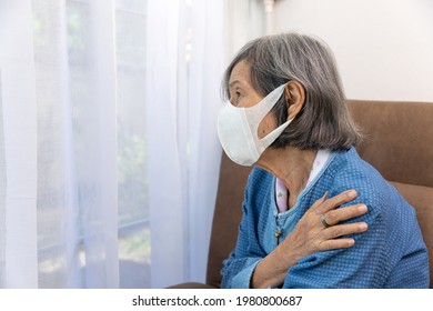 Elderly Asian Woman Wearing Surgical Mask Looking Through The Window ,covid19 Pandemic