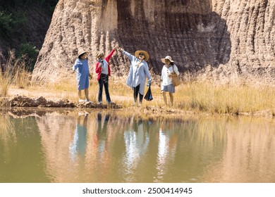 Elderly Asian women walking together on a dirt path on cliffside, group of pensioner senior female friends, recreation enjoying the nature walk on sunny day, society aging people friendship lifestyle - Powered by Shutterstock