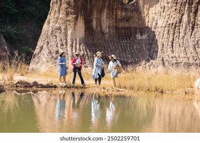 Elderly Asian women walking together on a dirt path on cliffside, group of pensioner senior female friends, recreation enjoying the nature walk on sunny day, society aging people friendship lifestyle - Powered by Shutterstock