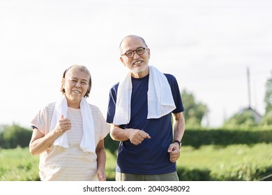 Elderly Asians jogging outside in the evening