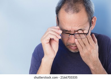 Elderly Asians Take Off Their Glasses Because They Are Tired. Due To Eye Strain And Have Vision Problems