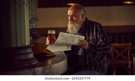 Elderly bearded man in checkered shirt sitting at warm lit bar, drinking beer, and reading newspaper. Relaxing vibes. Concept of elderly people lifestyle, drinks, retro fashion - Powered by Shutterstock